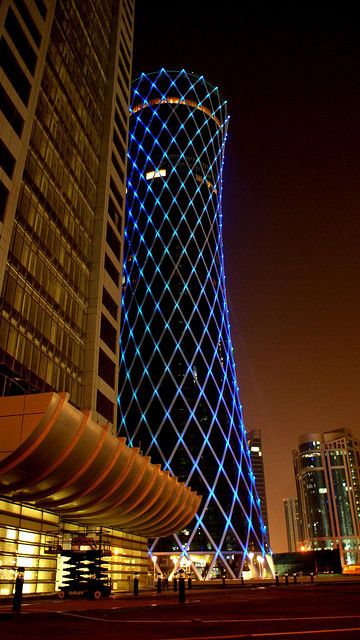 Tornado Tower in Doha, Qatar by SIAT Architekten + Ingenieure München Qatar Architecture, Unusual Buildings, City At Night, Facade Lighting, Interesting Buildings, Doha Qatar, Amazing Buildings, Unique Buildings, Unique Architecture