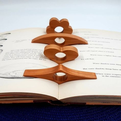 A thumb book page holder that'll ease the annoying task of constantly adjusting the moving pages while reading. No more creasing pages and the holder can be personalized! Book Buddies, Book Buddy, Thumb Book, Page Holder, Wooden Things, Unique Bookmark, Book Holder, Wood Book, Wooden Books