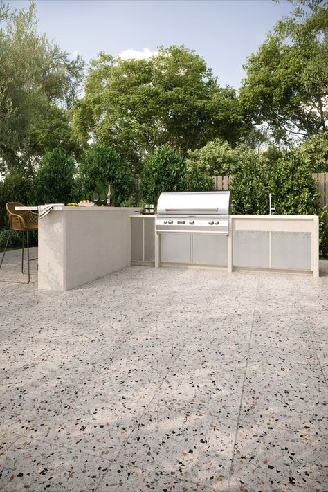 Outdoor kitchen space with terrazzo stone floor tile. Outdoor kitchen is complete with island, bar stools, and grill. Terrazzo Garden, Outdoor Terrazzo, Terrazzo Pool, Backyard Floor, Terrazo Flooring Patio, Terrazzo Patio, Terrazzo Tiles Outdoor, Terrazzo Patio Floor, Terrazzo Porch