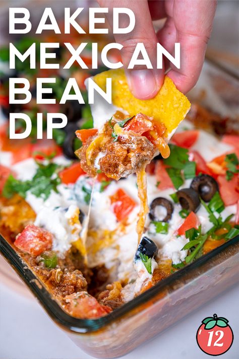 Baked Mexican Layer Dip | 12 Tomatoes Baked Mexican Layer Dip, Baked Mexican Dip, Layered Mexican Dip Recipe, Mexican Layer Dip Recipe, 7 Layer Mexican Dip, Mexican Bean Dip, Mexican Dip Recipes, Mexican Layer Dip, Seasoned Sour Cream