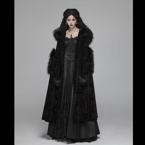 Reversed Snowfall Cloak ❄️ 🌬️ ❄️ A long, ornately damask-patterned velveteen cloak with an oversized hood and faux fur trims, embodying gorgeous gothic glamour. 🌚 Fastens at the neck with fabric cord ties, finished perfectly with black faux fur pom-pom embellishments. Fully lined for extra warmth in the winter months. 🦇 ☞ Tap the Pic to Shop! ⚓ We Ship Worldwide. 🕸 www.gothmall.com 💀 @gothmall 🦇 🕸 🦇 #goth #gothgoth #gothic #gothgirl #gothicgirl #gothfashion #gothicfashion #gothstyle #gothic... Winter Cloak, Fur Coat Outfit, Gothic Coat, Black Fur Coat, Long Fur Coat, Long Black Coat, Hooded Cloak, Punk Rave, Wedding Dress Trends