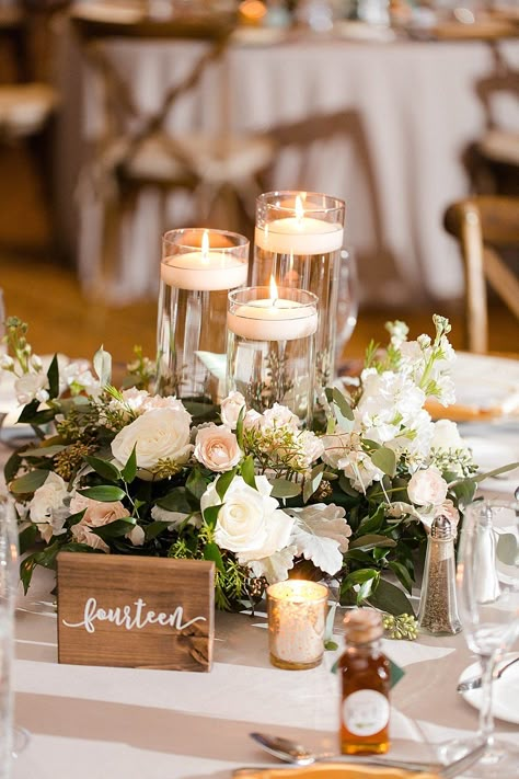 Rustic Elegant Wedding Reception Decor, White, Blush Pink, Ivory and Greenery Centerpiece with Tall Glass Cylinder Floating Candles and Wooden Table Number Sign Greenery Centerpiece, Harbor Wedding, Rustic Wedding Decorations, Rustic Elegant Wedding, Candle Wedding Centerpieces, Tafel Decor, Elegant Wedding Reception, Glass Cylinder, Flower Centerpieces Wedding