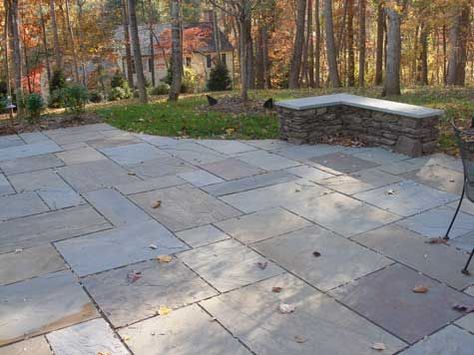 Bluestone patio with seat wall. Stone is dry laid which keeps the cost down. Bluestone is full range color which has various colors running through it for a natural look. Wall is stone and goes well with the patio. Paver Stone Patio, Seat Wall, Bluestone Pavers, Concrete Patios, Bluestone Patio, Stone Patio, Flagstone Patio, Wall Seating, Front Patio