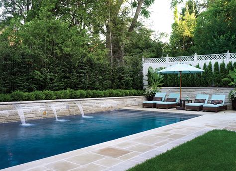 A simple backyard pool is elevated by the addition of waterfalls. Pool Waterfall Wall, Pool With Wall, Pool With Retaining Wall, Retaining Wall Pool, Simple Backyard Pool Designs, Pool Retaining Wall, Water Spouts, Simple Backyard, Rectangle Pool