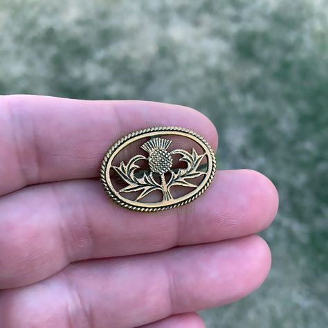 Small Scottish Thistle Pin - Bronze | Scottish Kilt Brooches / Pins. The Thistle is the national flower and has become the premier symbol of Scotland. Pendant: BronzeApprox. Size: 1.125" (2.9cm) wide x 0.75" (1.9cm) tall. Worldwide shipping available!US Customers: Typically ships in 1 business day, delivers in 2-5 days.Outside of US: See shipping options during checkout. Share this item: Scottish Accessories, Viking Brooch, Scottish Symbols, Thistle Jewellery, Cloak Clasp, Thistle Tattoo, Scottish Jewelry, Thistle Wedding, Thistle Design