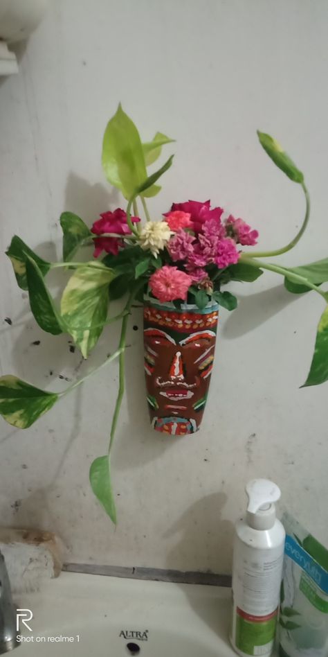 Tribal mask planter ,vase,flower arrangement,diy planter,,wall art,plastic bottle planter,shampoo bottle planter Flower Arrangement Diy, Plastic Bottle Planter, Planter Wall, Diy Planter, Flower Vase Arrangements, Vase Flower, Flower Arrangements Diy, Diy Planters, Plastic Bottle