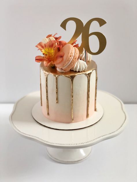 Peach to white gradient cake. Gold drip. Macarons, flowers, and meringues on top in a crescent arrangement. Gold topper reads “26”. Cute 26th Birthday Cake, Peach Colour Birthday Cake, Peach Colored Cake Ideas, 26 Th Birthday Cake, Cake For 27th Birthday, 27th Birthday Cake Ideas For Women, Birthday Cake 26th Birthday Girl, Cake 26 Birthday Woman, 26th Birthday Cake For Women