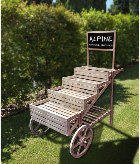 Add vibrant colored flowers to the wooden plant cart while giving your lawn or garden a classic country and farmhouse vibe. Use multiple ones together to create a small garden oasis or separate them to bring sweet style to any space.Plant stand measures 32"L x 55"W x 59"H, the perfect size for your yard, and includes a one year manufacturer's warranty from date of purchase . Small Garden Oasis, Cart Display, Roadside Stand, Briar Patch, Solar Light Crafts, Vegetable Stand, Wooden Cart, Support Pour Plante, Plant Stands Outdoor