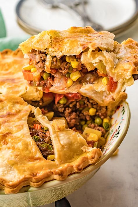 Cozy and comforting Beef Pot Pie is just the recipe for cool autumn evenings! Savory beef, tender potatoes, and a medley of carrots, corn, and peas make a robust filling sandwiched between two flaky crusts. Individual Meat Pies Ground Beef, Ground Beef Pot Pie Recipe Easy, Cornbread Pie Ground Beef, Ground Beef Pot Pie Recipe, Meat Pies Ground Beef, Steak Pot Pie, Easy Beef Pot Pie, Ground Beef Pot Pie, Roast Beef Pot Pie