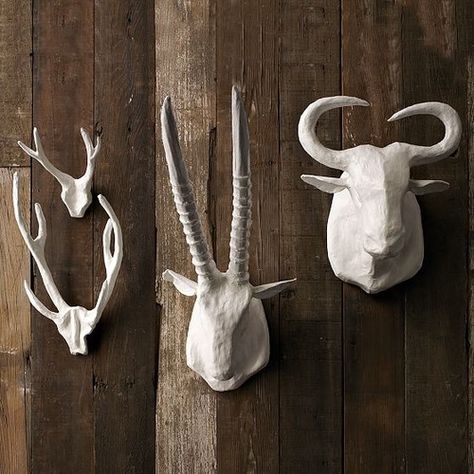 A grouping/line of antlers would look fantastic over your fireplace where the brick stops. The white gives it a modern rustic feel and would pop off the blue wall.    Papier-Mâché Animal Sculptures eclectic accessories and decor Paper Mache Animal Head, Paper Mache Wall Art, Decorating With Antlers, Fake Taxidermy, White Faux Taxidermy, Deer Heads, Paper Mache Animals, Paper Mache Sculpture, Faux Taxidermy