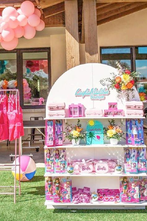 Take a look at this colorful Malibu Barbie birthday party! The party favor stand is amazing!! See more party ideas and share yours at CatchMyParty.com Party Decoration Business Ideas, Favor Stand Ideas, Diy Party Favor Stand, Malibu Barbie Birthday Party Food, Party Favor Stand, Barbie Souvenir Ideas, Barbie Unicorn Birthday Party, Barbie Party Favors For Boys, Barbie Beach Birthday Party