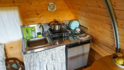 100 Sq. Ft. Off-Grid Micro Cabin on a Foundation in Portugal Micro Cabin Interior, Circular Door, Small Storage Shelves, Micro Cabin, Tiny House Vacation, Space Saving Hacks, Best Tiny House, Door Entry, Kitchen Board