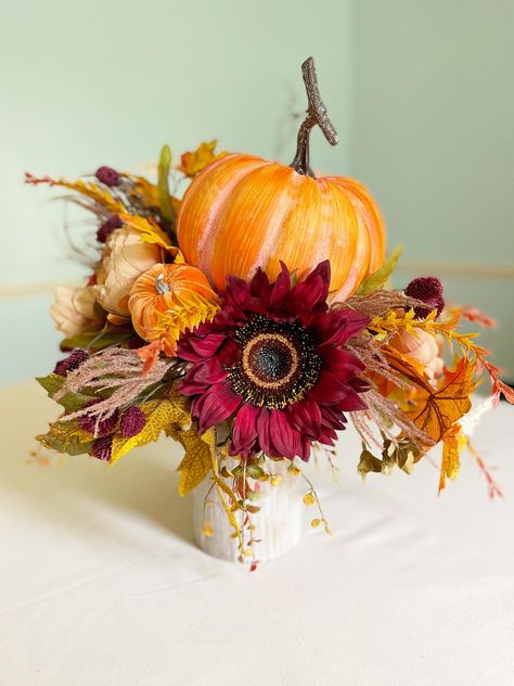 Bring the warmth and charm of autumn into your home with this handcrafted Fall Candlestick Centerpiece, featuring a delightful mix of pumpkins, sunflowers, and autumn greenery. This elegant Pumpkin Candlestick Arrangement is perfect for enhancing your seasonal decor with a touch of rustic beauty, making it a must-have for your fall gatherings and festive occasions. Why This Tall Fall Floral Arrangement is Perfect for You: 🍁 Custom-Designed Elegance: Each Pumpkin Candlestick Arrangement is individually handcrafted to offer a unique piece that elevates your fall decor. With rich, vibrant colors and lifelike florals, this Tall Fall Floral Arrangement for Thanksgiving Table becomes the focal point of any room, adding sophistication to your seasonal home styling. 🎃 Perfect for Welcoming Guest Fall Candlesticks, Pumpkin Candlesticks, Candlestick Arrangements, Fall Floral Arrangement, Elegant Pumpkins, Candlestick Centerpiece, Fall Floral Arrangements, Dining Room Buffet, Fall Arrangements