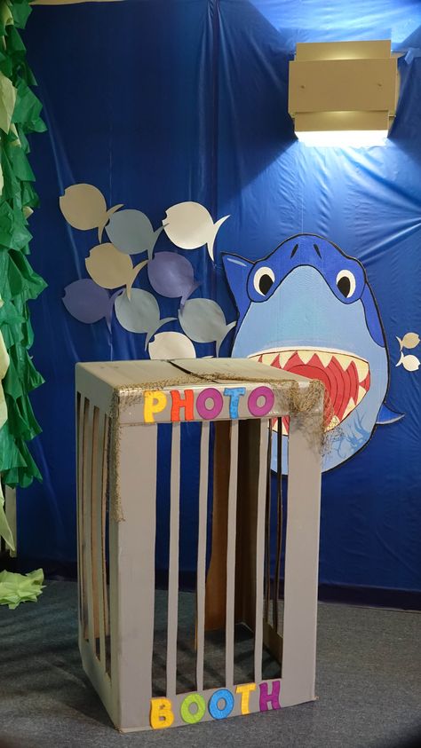 Photo booth-shark cage w/Bruce made by my partner in decorating, Kelcey.  Bruce hung by filament from light fixture then stabilized w/tape onto plastic table cover. Shark Photo Booth Diy, Shark Centerpiece Ideas, Diy Shark Party Decorations, Shark Birthday Decorations, Shark Week Party, Shark Themed Party, Shark Cage, Shark Themed Birthday Party, Plastic Table Cover