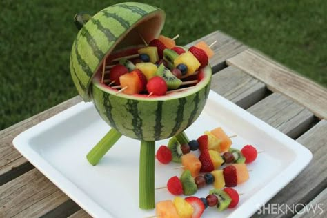 Watermelon grill with fruit kabobs You may have heard of grilled watermelon, but have you ever heard of a watermelon grill? Surprise guests at your next barbecue with this watermelon centerpiece that's functional and edible. Add some fruit kabobs, and you've got a grill that will thrill. Watermelon Centerpiece, Decorações Com Comidas, Watermelon Carving, Fruit Kabobs, Fun With Food, Veggie Tray, בר מצווה, Snacks Für Party, Fun Foods