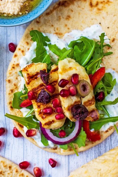 Perfectly grilled Halloumi with a drizzle of honey piled on to soft, fluffy Greek Flatbreads and then scattered with our favourite Greek inspired toppings. This wrap recipe is our go-to quick and easy lunch at the moment. This grilled cheese works well as an appetizer, in a sandwich, a burger, tacos or on skewers. #greek #mediterranean #flatbread #halloumi #cheese Gyro Flatbread Recipe, Halloumi Gyros, Gyro Flatbread, Soft Flatbread Recipe, Halloumi Pasta, Greek Flatbread, Cooking Halloumi, Mediterranean Flatbread, Burger Tacos