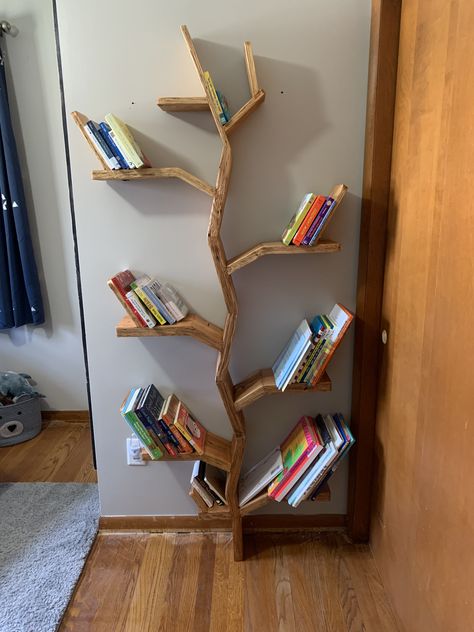 We have a nature kinda of vibe for my sons nursery with bear, moose, deer. We wanted to have a special bookshelf made for him and found this idea of a tree bookshelf. My father in law built this beauty! #boynursery #treebookshelf #nursey Tree Style Bookshelf, Wooden Tree Bookshelf Kids Rooms, Tree Bookcase Nursery, Nursery Tree Bookshelf, Tree Bookshelf Nursery, Diy Nursery Bookshelf, Woodland Bookshelf, Mountain Bookshelf, Diy Tree Bookshelf