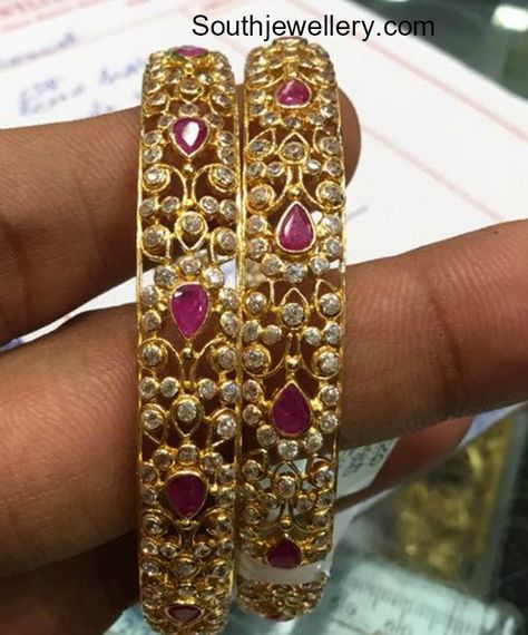 22 Carat gold bangles studded with rubies and cz stones by Premraj Shantilal jewellers.  stones bangle models, gold bangles, cz bangles, ruby bangle models Uncut Bangles Indian, Cz Bangles Indian Gold, Uncut Bangles, Stone Bangles Gold, Uncut Diamond Bangles, Bangle Models, Diwali Flowers, Cz Bangles, Kada Bangles