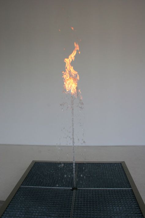 Water Flame is a mind-boggling installation by artist Jeppe Hein that features two opposing elements coexisting—water and fire. The installation, which is essentially a small fountain with a flame dancing atop the stream of cascading water, creates the paradoxical visual effect by dispelling a dose of natural gas through the water, making it flammable and able to emit a ball of fire at the center. Fire Art Installation, Fire Installation, Jeppe Hein, Festival Booth Display, Water Fountain Design, Water Sculpture, Sculpture Textile, Garage Guest House, Fountain Design