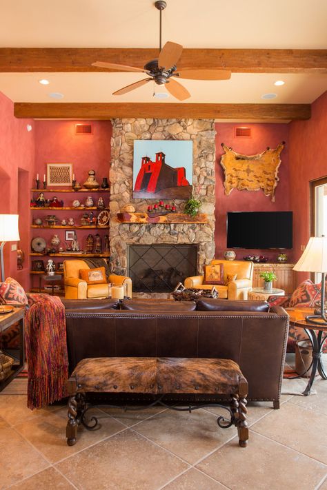 Mid-sized southwest open concept limestone floor and beige floor living room photo in Phoenix with red walls, a standard fireplace, a stone fireplace and a wall-mounted tv Southwestern Home Decor Living Room, Beige Floor Living Room, Southwestern Decorating Living Room, Santa Fe Living Room, Southwestern Living Room, Limestone Floor, Floor Living Room, Beige Floor, Southwestern Home Decor