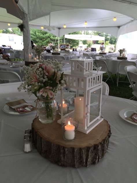 Centerpieces.  Mason jars filled with fresh flowers.  Ikea lantern with pillar candle.  Votives add more sparkle on slabs of wood for a rustic look.  They turned out perfect! Wedding Decorations Lanterns, Lantern And Vase Centerpieces, Table Centerpieces With Lanterns, Ikea Lantern Ideas, Simple Lantern Centerpieces, Glass Lantern Centerpieces, White Lantern Centerpieces, Lantern Wedding Centerpieces, Ikea Lantern