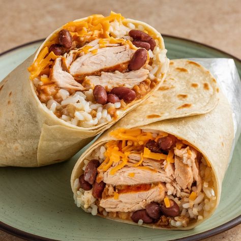 This Spicy Chicken Burrito is packed with flavor and ready in just 20 minutes! 🌯🔥 Perfect for a quick and delicious meal! **Ingredients:** - 2 cups cooked, shredded chicken - 1 cup cooked rice - 1 cup black beans, drained and rinsed - 1/2 cup corn kernels (fresh or frozen) - 1/2 cup shredded cheddar cheese - 1/2 cup salsa - 1/4 cup sour cream - 1 avocado, sliced - 4 large flour tortillas - 1 tablespoon olive oil - 1 teaspoon chili powder - 1/2 teaspoon cumin - Salt and pepper to taste **Di... Chicken Rice Burrito, Bean And Cheese Burrito, Chicken Burrito, Shredded Cheddar Cheese, Chicken Burritos, Cooked Rice, Flour Tortillas, Chicken Rice, Spicy Chicken