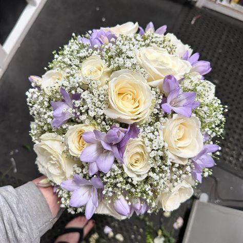 Bridal handtie bouquet of white roses, gypsophila and lilac freesia Wedding Bouquets Bride Lilac, White And Lilac Bouquet, Roses And Gypsophila Bouquet, Freesias Bouquet, Lilac Bouquet Wedding, Rose And Gypsophila Bouquet, Light Purple Wedding Flowers, Wedding Ideas Lavender, Lilac Flower Bouquet