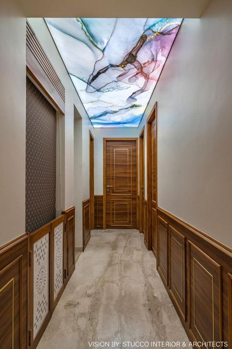 Hues of Grey and Brown to Create an Enigmatic Feel to this Modern Home | Stucco Interiors and Architects - The Architects Diary False Ceiling For Passage Area, Clinic False Ceiling Design, Passage Ceiling Design Modern, Passage Wall Design Modern, Ceiling Design For Lobby, Passage Ceiling Design, Lobby Ceiling Design, Site Context, Latest Cupboard Designs