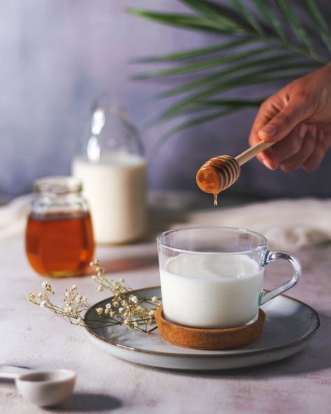 Pouring honey drops in a cup of milk Milk And Honey Aesthetic, Syrup Photography, Honey Pouring, Honey Shoot, Milk With Honey, Almond Milk Brands, Warm Milk And Honey, Milk Photography, Bike Cakes