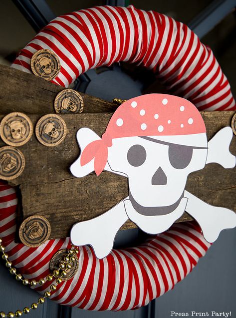 DIY PIRATE PARTY WREATH with free printable skull and crossbones pirate w an eye patch. Pirate party decorations ideas. Great to decorate the entrance to your pirate party with full video tutorial. Fun pirate great for kids parties. Can be made with items from the dollar store. Centerpiece of a Halloween pirate ship on the front porch made with cardboard. Check out all the pirate party posts. #pirate #party #decorations #wreath #diy - By Press Print Party! Jellyfish Costume Diy, Diy Pirate Party, Halloween Pirate Party, Pirate Room Decor, Pirate Door, Pirate Wreath, Ghost Lollipops, Baby Shower Mad Libs, Pirate Halloween Party