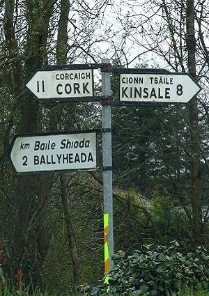 Road signs in Gaelic and English, with distances in kilometers, in County Cork, IRELAND Ireland Images, Kinsale Ireland, Ireland Cork, Critter Sitters, Irish Things, Irish Heart, Ireland Aesthetic, County Cork Ireland, Irish Eyes Are Smiling