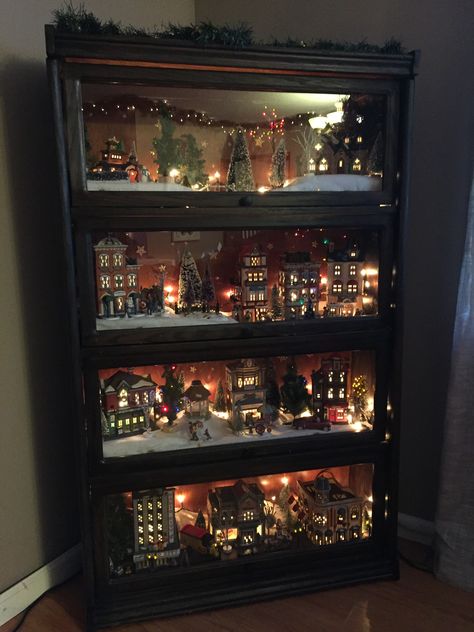 Refinished glass bookshelf for the village.  Also keep it safe from roaming, curious cats! Christmas Decorations On A Budget, Decorations On A Budget, Christmas Tree Village, Diy Christmas Decorations For Home, Diy Christmas Village, Christmas Village Houses, Christmas Village Display, Village Display, Diy Christmas Decorations