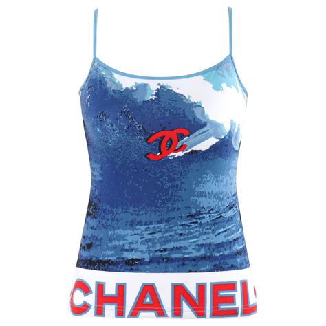 CHANEL 2002 Red White Blue CC Surf Wave Screen Print Stretch Elastic Spaghetti Strap Tank Top Brand / Manufacturer: Chanel Collection: The Surf Line 2002 Label(s): Numbered - 02S / P19521V01125 / B2008 Designer: Karl Lagerfeld Style: Spaghetti strap tank top Color(s): Shades of blue, white, and red Lined: No Marked Fabric: 92% Cotton, 8% Spandex Additional Details / Inclusions: Chanel 2002 'The Surf Line' spaghetti strap tank top. Shades of blue wave print over white base. Iconic Chanel logo and White Y2k Tank Top For The Beach, Off White Clothing Brand, Chanel Race Car Top, Cool Tank Tops, White Y2k Cotton Tank Top, Red Cotton Y2k Tank Top, Off White Brand, Chanel Striped Top, Chanel Clothes