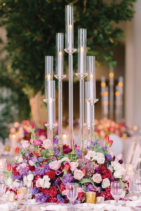 Candelabra Centerpiece with Pink & Purple Flowers Acrylic Candelabra Centerpiece, Candleabras Wedding Centerpiece, Candleabra Wedding, Colorful Wedding Reception, Candelabra Flowers, Embellished Veil, The Corinthian, Pink Purple Flowers, Candelabra Centerpiece