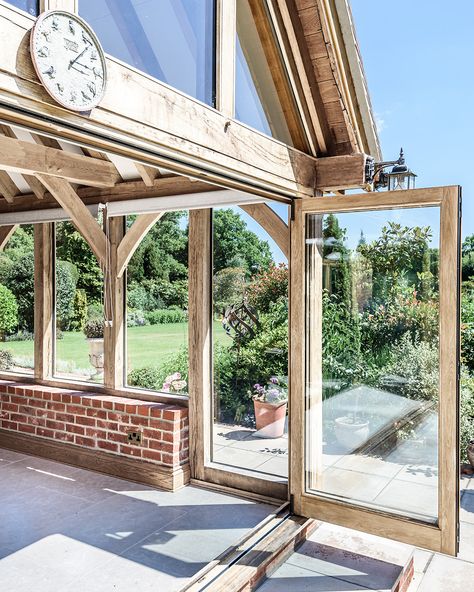 By installing bifold doors, you can create a space that seamlessly merges your interior & exterior environments, allowing for an unobstructed view & easy access to your garden, patio, or balcony. This not only enhances the overall flow of your home but also brings in an abundance of natural light, making your living space feel brighter & more spacious.  #homeandgarden #homerenovation #bifolddoors #frenchdoors #outdoorindoorliving #outdoorliving #modernhomes #oakbuildings Oak Bifold Doors, Prime Oak, Orangery Extension, Cotswold Cottage, Garden Room Extensions, Oak Framed Buildings, Blue Barn, Exposed Rafters, Room Extensions