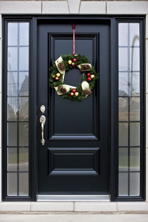 Here's a truly bespoke black door, with silver hardware, flanked by a pair of smoked glass windows. Black Front Door, Front Door, Wreath, Doors, Christmas Decorations, Christmas, Black