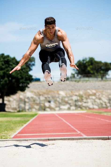 Athlete performing a long jump by Wavebreakmedia. Athlete performing a long jump during a competition #Sponsored #long, #performing, #Athlete, #competition Jumping Photography, Male Cheerleaders, Jumping Poses, Field Athletes, Soccer Goalie, Cheer Practice, Us Olympics, Long Jump, Artistic Gymnastics