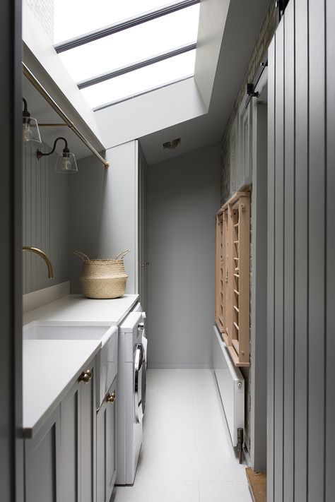 A functional use of a compact space in this utility room in a recently completed project in Dartmouth Park, North London. Ideal components of a utility are a rail for hanging, sink, drying rack, integrated laundry basket and a bench large enough to fold clothes. London Utility Room, Small Narrow Utility Room, Utility Room Hanging Rail, Utility Room In Kitchen, Utility Room Narrow, Long Utility Room, Windowless Utility Room, Utility Drying Rack, Mudroom Utility Room