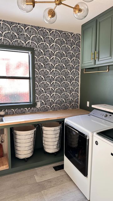 CONSTANCE | HOME DECOR & DIY on Instagram: "Our laundry/mudroom reveal: part one! 🧺 Would you believe me if I said this space was our kitchen before the renovation?🤯 But, that’s for another day! I fell in love with this green color from a hand soap bottle I had so I brought it to Home Depot to color match and the inspiration grew from there! Wallpaper in the laundry room is a must for me! I like pretty spaces because they make me happy aaannnd laundry doesn’t make me happy 🤣 What’s your favorite part of this space? Comment below and let me know!🤍 I can’t wait to completely finish it! #. . . #laundry #before #after #mudroom #paint #butcherblock #diy #home #homedecor #moody" Laundry Room With Wallpaper Ceiling, Laundry Room Design Wallpaper, Laundry Room Olive Green, Green Laundry Room Wallpaper, Dark Olive Laundry Room, Laundry Room With Grey Cabinets, Small Laundry Room Green Cabinets, Green Laundry Room With Wallpaper, Laundry Room Moody