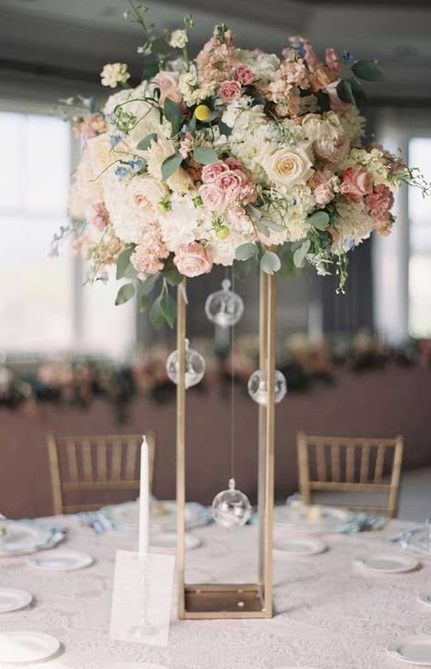 You’ve probably decided what your wedding theme is. Wedding reception centerpieces should be beautiful, but they don’t have to be difficult. There’s no need... Cheap Wedding Table Centerpieces, Wedding Table Pink, Tall Wedding Centerpieces, Tafel Decor, Wedding Floral Centerpieces, Tall Centerpieces, Flower Centerpieces Wedding, Wedding Table Decorations, Wedding Flower Arrangements