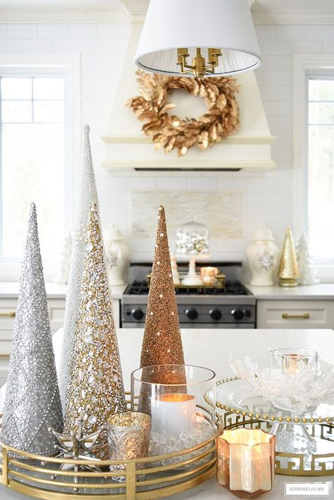 Elegant Christmas kitchen decorating with gold, silver and white. Glittery tress on a brass tray is the perfect touch on the kitchen island! #christmasdecor #christmasdecorating #christmaskitchen #christmasideas #christmastrees #holidaydecorating Silver Gold Christmas, Glam Christmas Decor, Christmas Cones, Silver Christmas Decorations, Elegant Christmas Decor, Rose Gold Christmas, Glam Christmas, Cone Christmas Trees, Christmas Decor Inspiration