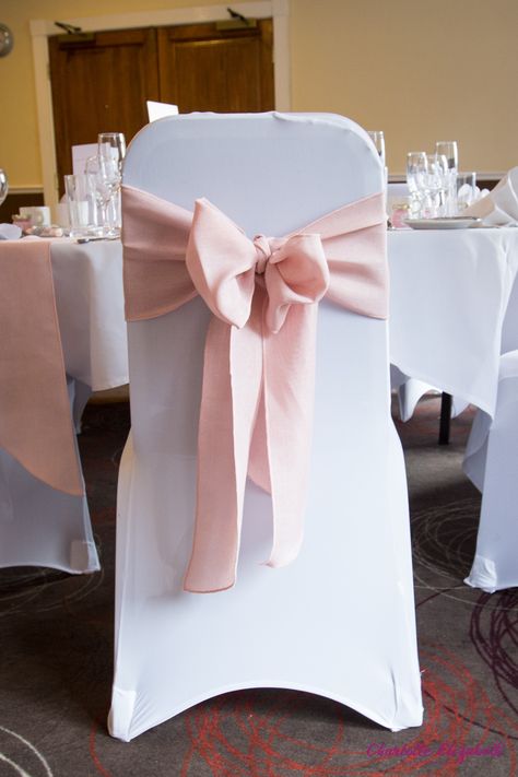 Baby pink chair ribbon on a white chair cover. Part of Gemma & Michaels's real wedding. Table And Chair Decorations For Party, Party Chairs And Tables, Pink Wedding Chairs, Pink Table And Chairs, Ribbon Chairs Wedding, Ribbon On Chairs Wedding, Covered Chairs Wedding, Quince Chair Decorations, Chair Ribbons Wedding