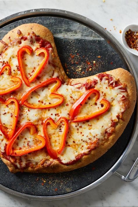 Shaping a round a pizza dough into a heart is an easy way to make a healthy vegetable pizza whimsical and fun. In additional to the heart-shaped dough, slices of red pepper form decorative heart shapes on the pizza. For the most impact, use a pepper that has a deep curve at the stem. #valentinesday #valentinesdayrecipes #recipesfortwo #valentinesdinner #recipe #eatingwell #healthy Pizza Recipe Video, Caprese Pizza, Decorative Hearts, Shaped Pizza, Recipes Pizza, Fruit Pizza Sugar Cookie, Heart Shaped Pizza, Fruit Pizza Recipe, Bell Pepper Recipes