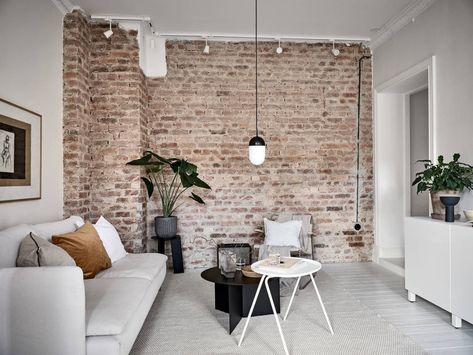 Scandinavian living room with exposed brick wall Brick Wall Living Room, Brick Wall Decor, Brick Feature Wall, Brick Living Room, Brick Interior Wall, Brick Interior, Minimalist Living Room Decor, Scandinavian Apartment, Exposed Brick Walls