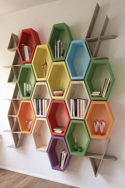 This image captures an innovative wall-mounted shelving unit designed in a hexagonal honeycomb pattern. The multi-colored compartments are both eye-catching and practical, offering an artistic way to organize books and ornaments while saving space. Ideal for adding a modern touch to any room’s decor. Hexagon Pattern Wall Design, Wall Mounted Shelving Unit, Organize Books, Library Wall, Mom Ideas, Wall Bookshelves, Book Organization, Hexagon Pattern, Honeycomb Pattern