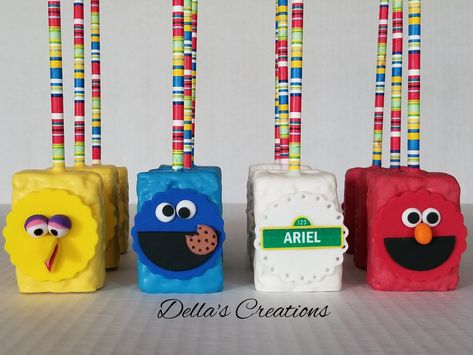 Sesame street themed chocolate covered Rice Krispy treats Sesame Street Rice Krispie Treats, Elmo Rice Crispy Treats, Elmo Rice Krispie Treats, Sesame Street Birthday Treats, Sesame Street Desserts, Sesame Street Treat Table, Elmo Treat Table, Sesame Street Birthday Treat Table, Sesame Street Cake Pops