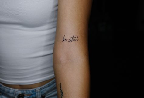 Be Still Arm Tattoo, Be Still Tattoo Font Simple, Meaningful Rib Tattoos For Women, Be Still Tattoos For Women, Upper Elbow Tattoos For Women, Be Still And Know That I Am God Tattoo, Be Still Tattoo Font, Peace Be Still Tattoo, Be Still And Know Tattoo