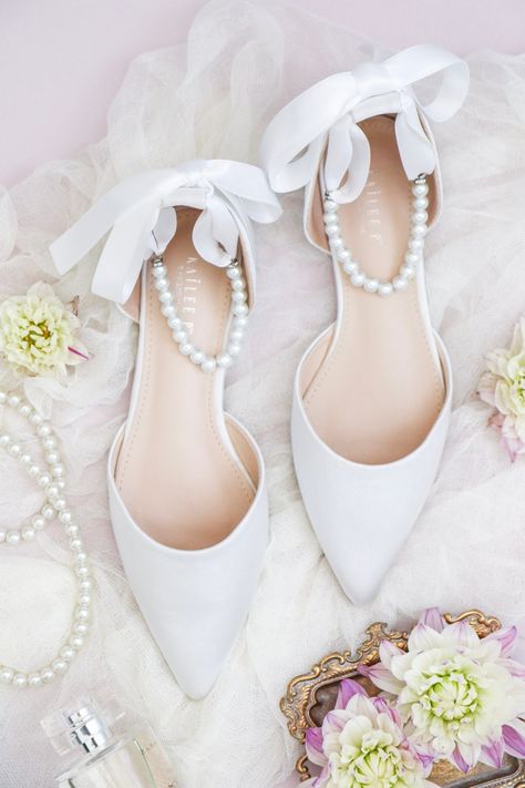 "Satin pointy toe flats with beautiful row of pearls as ankle strap. Comfortable throughout your special day and perfect for holiday party, night out and wedding party. YOU CAN CHOOSE THE PEARLS ANKLE STRAP AT CHECKOUT Details: COLORS AVAILABLE: Black, Burgundy, Champagne, Dusty Pink, Hunter Green, Ivory, Light Blue, Navy, Red, Royal Blue, Silver, and White UPPER: Synthetic upper and lining MATERIALS: Manmade outsole Heel height: 0.625\" STYLE NAME: BELLA SIZE FIT: RUNS LARGE, ORDER HALF SIZE DO Bride Shoes Flats, Wedding Flats For Bride, Bride Flats, Wedding Shoes Women, Satin Wedding Shoes, White Bridal Shoes, Shoes Bride, Bridal Flats, Bridal Shoes Flats