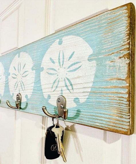 "Beach House Hook Rack ⚓️This is an Original Design by Waverly Home Designs⚓️ Handmade on 3/4\" boards.  Each sign is carefully selected, distressed, and painted by hand.  There may be knots, natural imperfections, and raised wood grains for a one of a kind piece.  Sand Dollar Sign with 3 hooks makes a great addition to your entryway, mud room, porch, kitchen, or anywhere you want to keep your keys and dog leash accessible & organized.  Dimensions are approximately 24 W x 7-1/4\"   If you would Beach Home Accessories, House Interior Beach Coastal, Florida Beach Decor, Fun Beach House Decor, Beach Theme House Interior Design, Beach Wood Crafts, Beach Bathroom Ideas Coastal Style, Rustic Beach Cottage, Beach Decor Diy