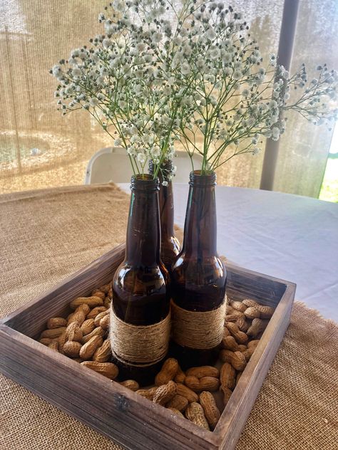 A Baby is Brewing 👶🏻🍺 Baby Shower decor Couples Baby Shower Gifts, Grandpa Birthday Decoration Ideas, Rustic Retirement Party Ideas For Men, Bro Shower Ideas, Couples Shower Centerpieces, Western Centerpiece Ideas For Men, Bottles And Brews Party, Beer Bottle Centerpieces For Men, Brewery Party Decor